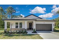 New construction home with stone accents and a two-car garage at 12326 Deep Creek Dr, Spring Hill, FL 34609