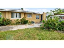 Backyard with storm damaged shed and partially damaged home at 105 14Th W St, Palmetto, FL 34221