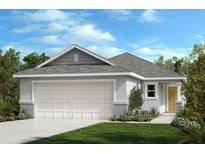 One-story home with gray siding, two-car garage, and landscaping at 37600 Williamette Way, Zephyrhills, FL 33540