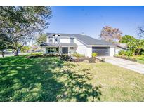 Charming two-story home with fresh landscaping, driveway, an attached garage and a well manicured lawn at 6370 Conniewood Sq, New Port Richey, FL 34653