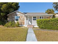 Charming stone house with a well-manicured lawn and walkway at 4035 Fairfield S Ave, St Petersburg, FL 33711