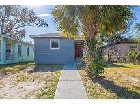 Charming blue home with a welcoming front path and mature palm tree at 2558 12Th S Ave, St Petersburg, FL 33712