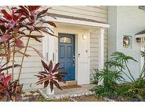 Inviting house entrance with a blue door and lush landscaping at 702 W Bay St # B, Tampa, FL 33606