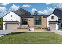 Modern two-story home with a black metal roof, brick and white siding, and a landscaped front yard at 1046 Snell Isle Ne Blvd, St Petersburg, FL 33704
