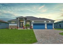 Beautiful single-story home with a three-car garage, brick driveway, and well-manicured lawn at 243 Rotonda S Blvd, Rotonda West, FL 33947