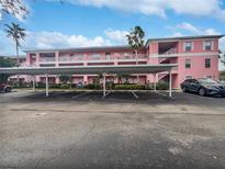 Pink apartment building exterior with covered parking at 2061 Willow Hammock Cir # 107, Punta Gorda, FL 33983