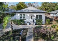 Charming white bungalow with landscaped yard and paved driveway at 603 W Emma St, Tampa, FL 33603