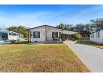 Charming single-story home with a carport and landscaped yard at 4920 Sedeno Dr, Zephyrhills, FL 33541