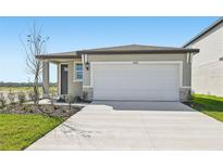 Charming one-story home with a two-car garage and well-maintained front yard landscaping at 14061 Crutchfield Ct, Parrish, FL 34219