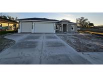 New construction home with a two-car garage and landscaped yard at 2840 S Biscayne Dr, North Port, FL 34287