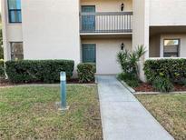 Well-maintained condo building with landscaped walkway leading to private entrance at 601 Shreve St # 51A, Punta Gorda, FL 33950