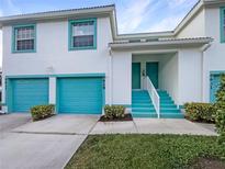 Two-story condo building with teal garage doors and accents at 6629 Pineview Ter # 5-201, Bradenton, FL 34203
