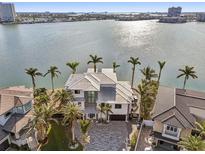 Aerial view of waterfront home with palm trees and a large driveway at 7801 9Th S Ave, St Petersburg, FL 33707