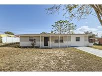 Updated one-story home with a covered porch and well-maintained lawn at 4404 Terry Loop, New Port Richey, FL 34652