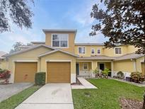 Attractive two-story townhome with a two-car garage and well-manicured lawn at 4580 Limerick Dr, Tampa, FL 33610