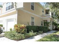 Tan two-story house with a two-car garage and well-manicured landscaping at 6302 Rosefinch Ct # 104, Lakewood Ranch, FL 34202