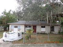 Ranch-style home with stone facade and mature trees at 733 Holly Ter, Brandon, FL 33511