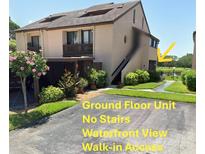 Inviting two-story condo with a waterfront view, no stairs, and ground-floor access, surrounded by well-maintained landscaping at 1322 Pelican Creek Xing # B, St Petersburg, FL 33707