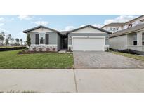 Charming single-story home with stone accents and a well-manicured lawn at 1886 Draughton Dr, Zephyrhills, FL 33541