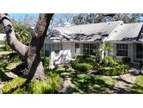 Well-maintained single-story home with lovely landscaping, shrubs and walkway at 4215 Edgewood Dr, Holiday, FL 34691