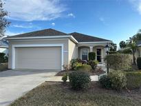 Charming home with a well-manicured front yard, attached garage, and beautiful landscaping at 5320 Aqua Breeze Dr, Bradenton, FL 34208