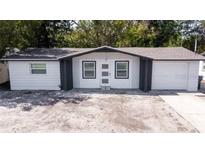 Charming single-story home featuring a new paint job, an attached one-car garage, and a spacious front yard at 3818 Moog Rd, Holiday, FL 34691