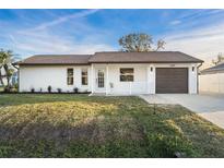 Charming single-story home featuring a well-maintained lawn and inviting curb appeal with a single car garage at 4107 Mulgrave Ave, North Port, FL 34287