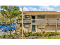 Attractive two-story condo with a well-maintained exterior and verdant landscaping at 6320 Newtown Cir # 20B1, Tampa, FL 33615
