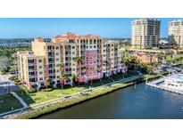 Stunning waterfront condominium with vibrant colors, multiple balconies, and lush landscaping at 606 Riviera Dunes Way # 604, Palmetto, FL 34221