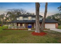 Charming two-story brick home with a welcoming front porch and well-maintained lawn at 6604 Stafford Terrace Ave, Plant City, FL 33565