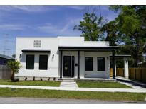 Charming single-story home with modern design elements, manicured lawn, and inviting entrance at 2604 E 11Th Ave, Tampa, FL 33605