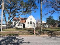 Charming home with a unique architectural style, featuring a tile roof and arched windows at 1827 2Nd E Ave, Bradenton, FL 34208