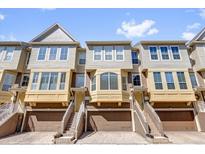 Townhome exterior featuring a three-story facade, drive-in garages, and private entrances at 4324 Spinnaker Cove Ln, Tampa, FL 33615