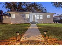 Charming home featuring a walkway with stylish outdoor lighting leading to the front entrance at 1766 12Th N Ave, St Petersburg, FL 33713