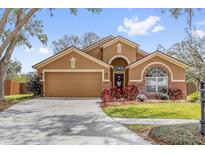 Charming single-story home with a well-manicured lawn, two car garage, and tasteful landscaping at 2727 Brookville Dr, Valrico, FL 33596