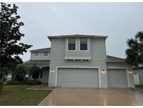 Two-story home with a three-car garage and manicured landscaping offers an appealing curb presence at 7108 Harvest Glen Ln, Riverview, FL 33578
