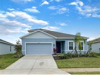 Charming single-Gathering home with a two-car garage, lush landscaping, and a well-maintained front lawn at 6310 116Th E Ave, Parrish, FL 34219