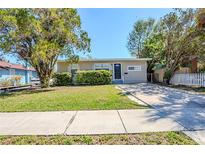 Charming single-story home with a well-maintained lawn and mature trees at 1542 39 S St, St Petersburg, FL 33711