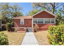 Charming brick home with a well-manicured front yard and walkway leading to the entrance at 2011 10Th S St, St Petersburg, FL 33705
