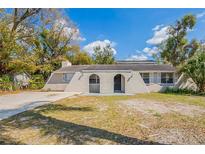 Charming one-story home features stucco and lush landscaping in a peaceful neighborhood at 3207 N 45Th St, Tampa, FL 33605