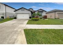 Beautiful single Gathering home with a well-manicured lawn and attached two car garage at 9793 Rally Spring Loop, Wesley Chapel, FL 33545