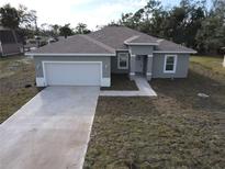 Charming one-story home featuring a two-car garage and a well-maintained yard and concrete driveway at 383 Yeager St, Port Charlotte, FL 33954