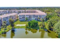 Beautiful lakefront condo complex with lush landscaping and serene water views at 3672 Lake Bayshore Dr # K327, Bradenton, FL 34205