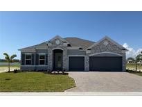 Beautiful single Gathering home with stone accents, a two-car garage and new landscaping at 25164 Calusa Dr, Punta Gorda, FL 33955