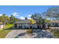 Charming single-story duplex featuring a well-manicured lawn and a convenient shared driveway at 1618 39Th Avenue E Dr, Ellenton, FL 34222