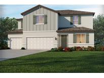Charming two-story home featuring a two car garage and welcoming front lawn at 1818 Draughton Dr, Zephyrhills, FL 33541