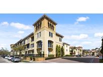 Charming condo complex featuring a stucco facade, tower accents, and well-maintained landscaping at 116 S Obrien St, Tampa, FL 33609