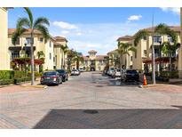 Inviting street view featuring a brick road, charming architecture, and lush landscaping with palm trees at 116 S Obrien St, Tampa, FL 33609