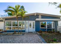 Charming single-story home featuring a brick walkway, lovely landscaping and a delightful facade at 10952 61St Ave, Seminole, FL 33772