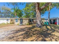 Charming single-story home featuring a well-maintained lawn and mature trees offering ample shade at 10151 114Th N Ter, Largo, FL 33773